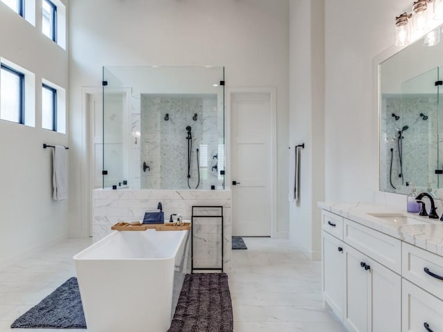 bathroom with vanity, separate shower and tub, and a towering ceiling