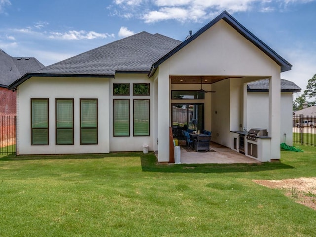 back of property featuring ceiling fan, a yard, and a patio