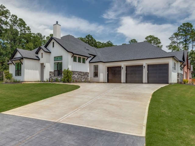 view of front of house featuring a garage and a front lawn