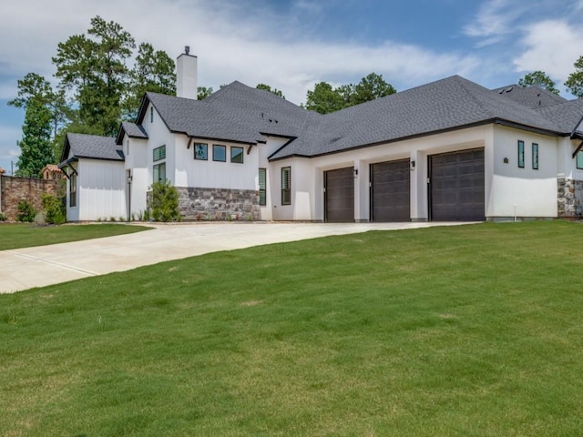 view of front of home featuring a garage and a front lawn