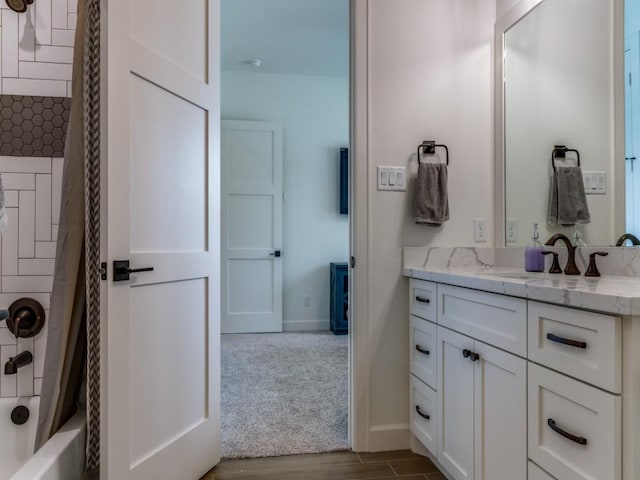 bathroom with shower / tub combo with curtain, vanity, and wood-type flooring