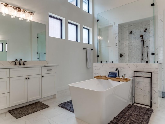 bathroom featuring vanity, a towering ceiling, and plus walk in shower