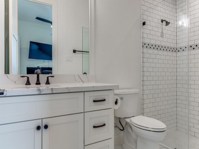 bathroom with vanity, toilet, and a shower with door