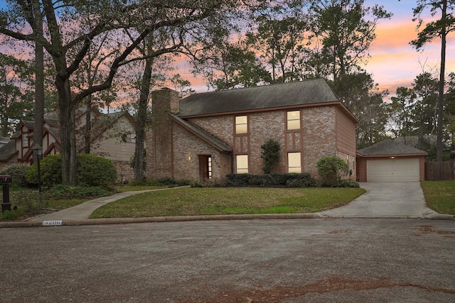 view of front of property featuring a yard and a garage