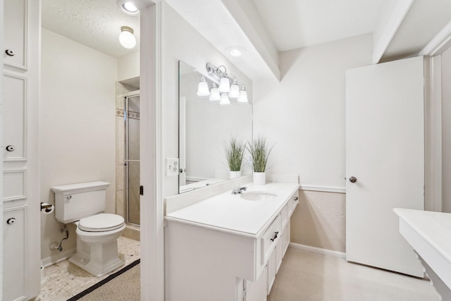 bathroom featuring vanity, toilet, a shower with shower door, and a textured ceiling