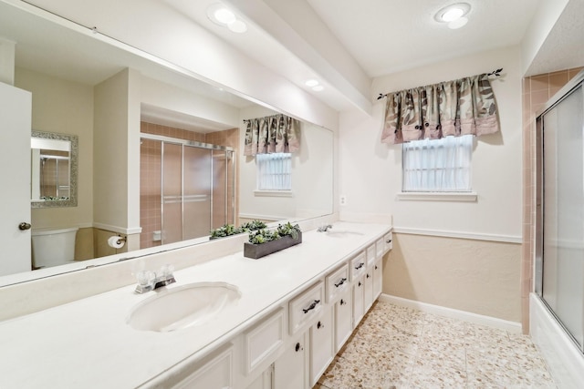 full bathroom with shower / bath combination with glass door, vanity, and toilet