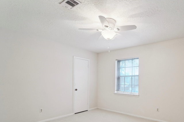 empty room featuring a textured ceiling, ceiling fan, and light carpet