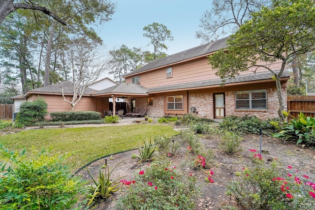 back of property featuring a patio area and a yard