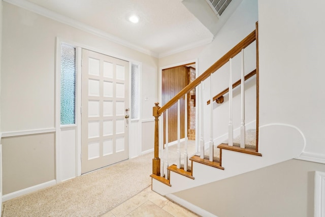 entryway featuring light colored carpet and ornamental molding