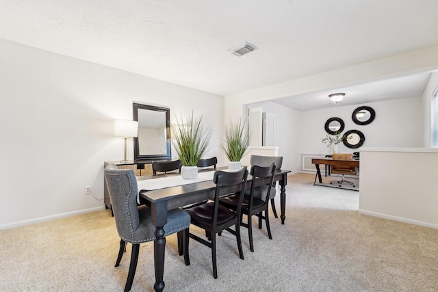 dining area featuring light colored carpet