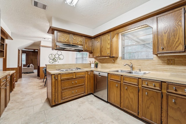 kitchen featuring gas cooktop, a textured ceiling, stainless steel dishwasher, and sink