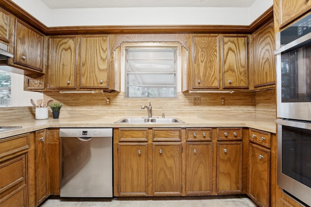 kitchen featuring tasteful backsplash, sink, a healthy amount of sunlight, and appliances with stainless steel finishes