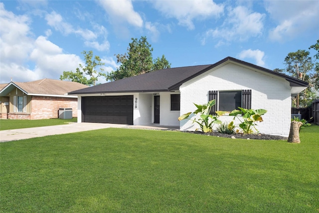 ranch-style home featuring a garage and a front lawn