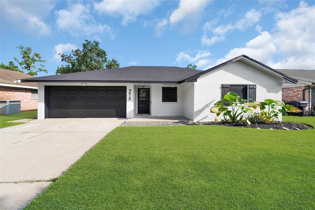 ranch-style house featuring a front lawn, cooling unit, and a garage