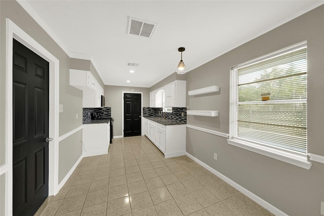 kitchen featuring pendant lighting, light tile patterned flooring, white cabinets, and backsplash