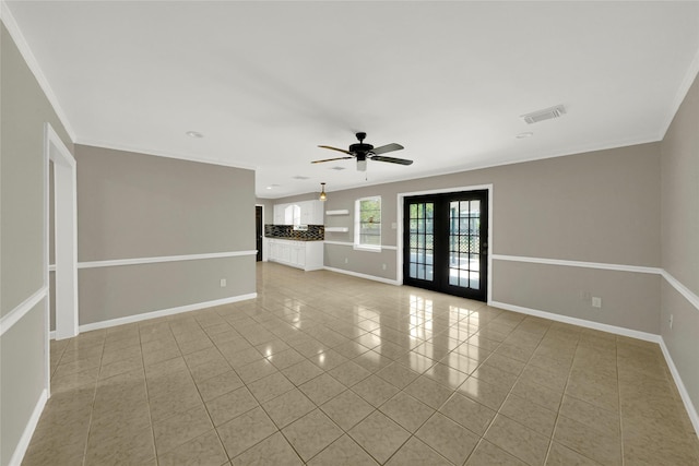 spare room with ceiling fan, light tile patterned flooring, ornamental molding, and french doors