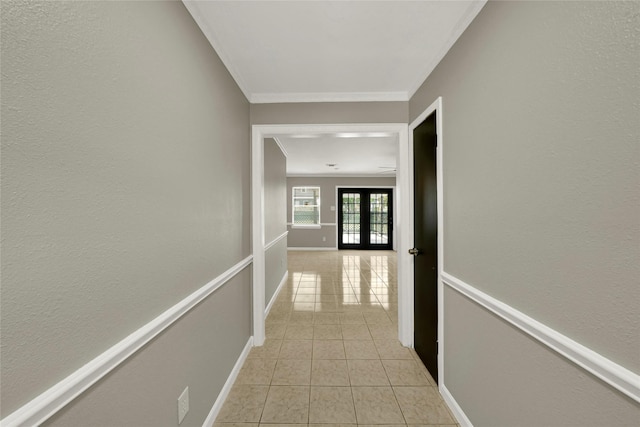 hallway featuring french doors, light tile patterned floors, and ornamental molding