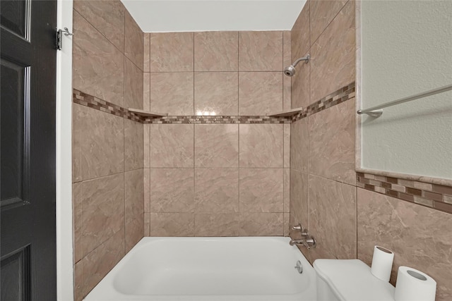 bathroom featuring tile walls and tiled shower / bath