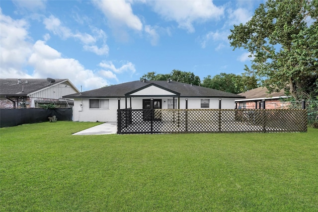 back of house with a lawn and a patio area