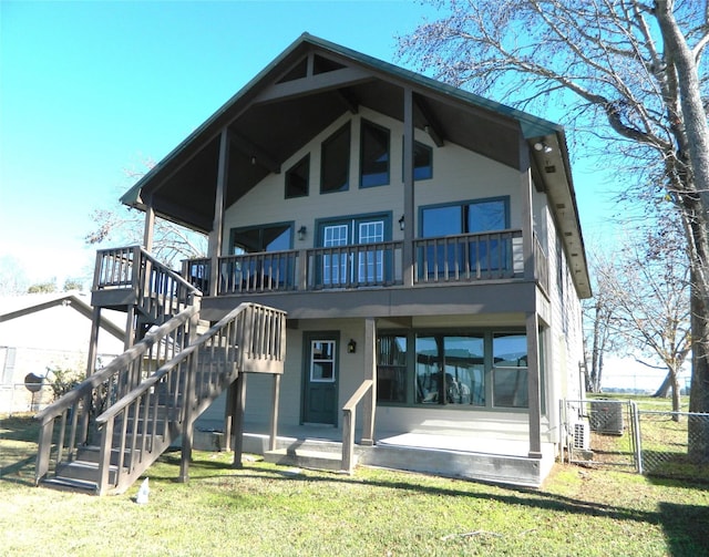 rear view of property with a lawn, cooling unit, and a patio area