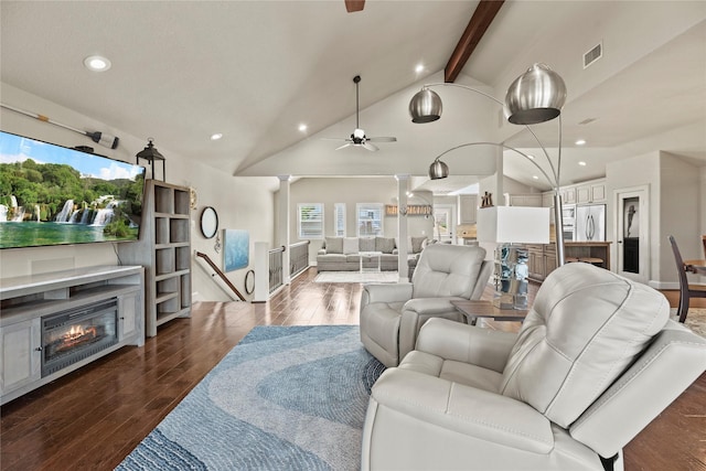 living room with vaulted ceiling with beams, ceiling fan, and dark hardwood / wood-style flooring