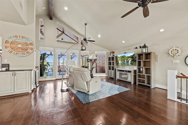 living room featuring a fireplace, beam ceiling, dark hardwood / wood-style floors, and a healthy amount of sunlight