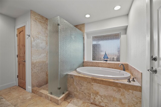 bathroom featuring shower with separate bathtub