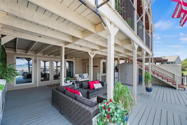 wooden deck featuring an outdoor living space and french doors