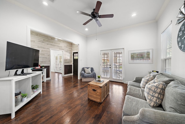 living room with a wealth of natural light, ceiling fan, french doors, and dark wood-type flooring