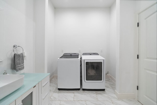 washroom with sink and washing machine and clothes dryer