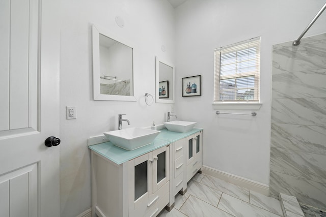 bathroom with vanity and a tile shower