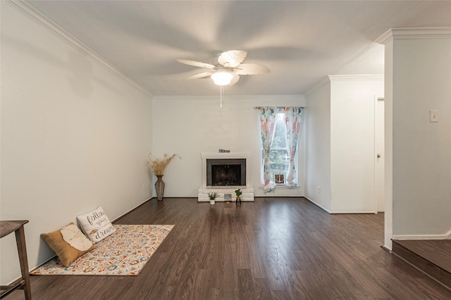 unfurnished living room with ceiling fan, dark hardwood / wood-style flooring, and ornamental molding