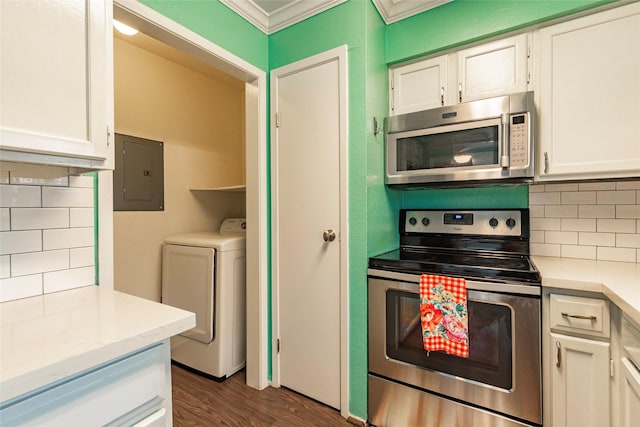 kitchen with washer / dryer, electric panel, stainless steel appliances, and white cabinetry