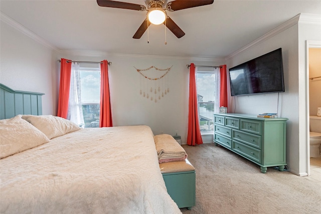 carpeted bedroom with ceiling fan, ornamental molding, and ensuite bathroom