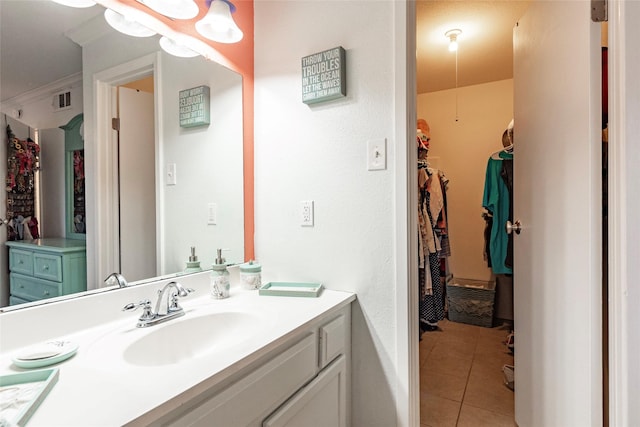 bathroom featuring tile patterned floors, vanity, and crown molding