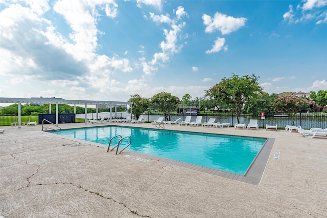 view of pool featuring a patio area and a water view