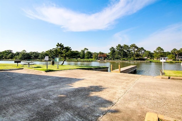 view of property's community featuring a water view and a dock