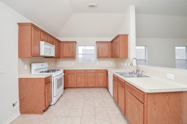 kitchen featuring kitchen peninsula, a healthy amount of sunlight, white appliances, and sink