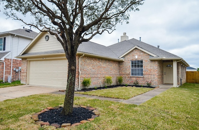 view of front of house with a front yard and a garage