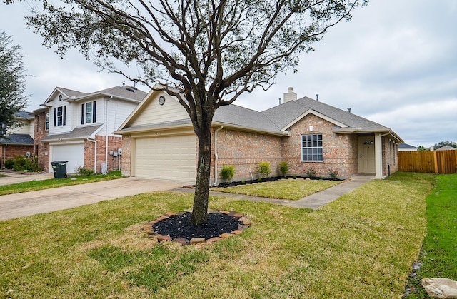 view of front of property featuring a garage and a front lawn