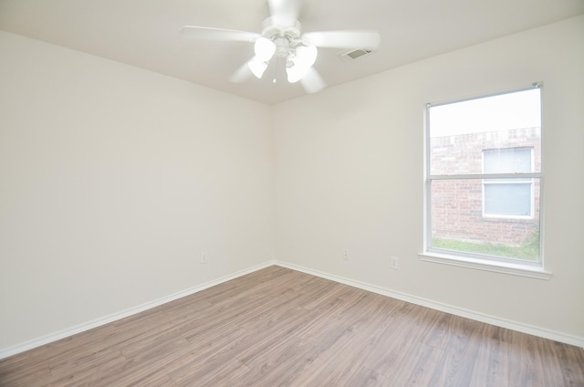 empty room with ceiling fan and light wood-type flooring