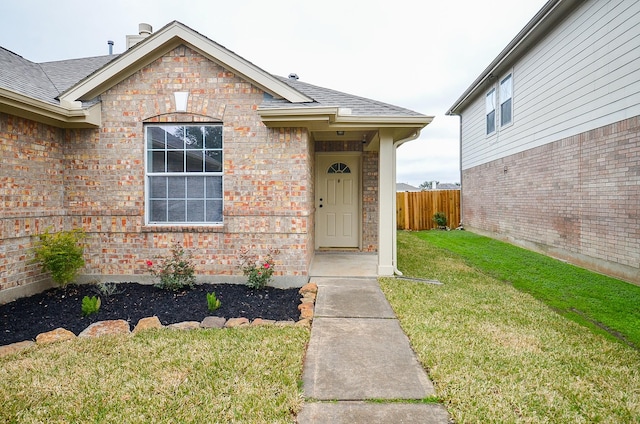 doorway to property featuring a lawn