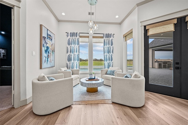 living room with hardwood / wood-style flooring and crown molding