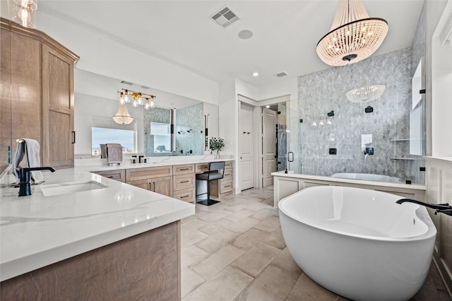 bathroom with shower with separate bathtub, vanity, and a notable chandelier