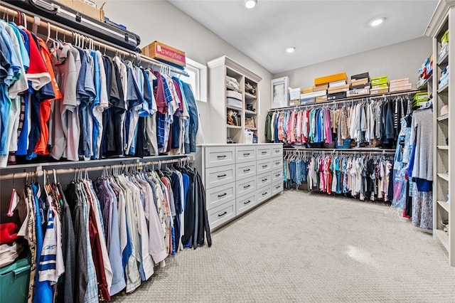 walk in closet featuring light carpet