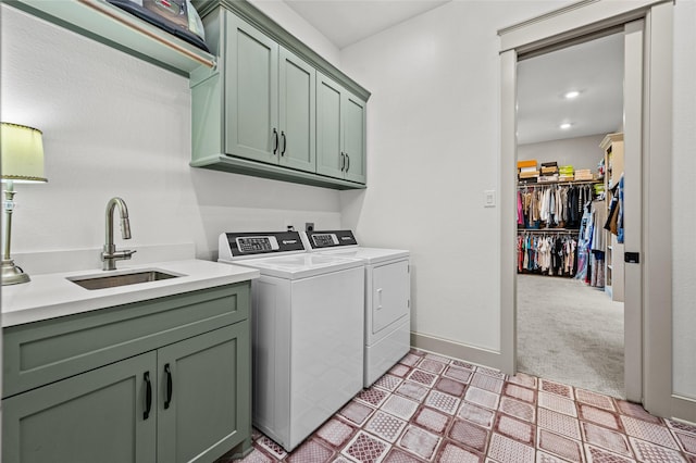 washroom featuring sink, light colored carpet, cabinets, and independent washer and dryer