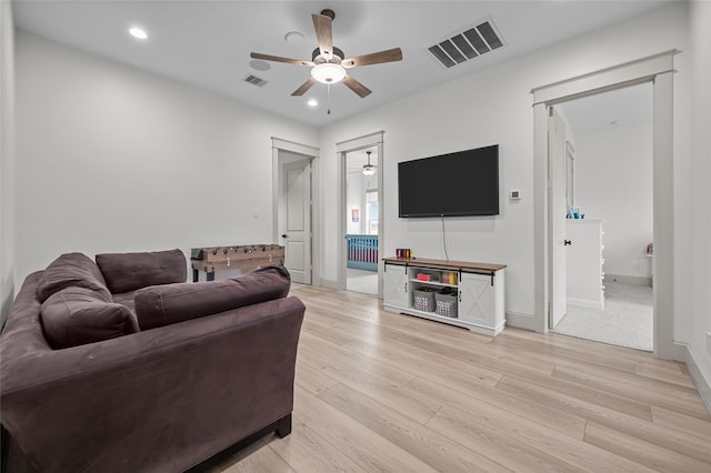 living room with ceiling fan and light hardwood / wood-style floors