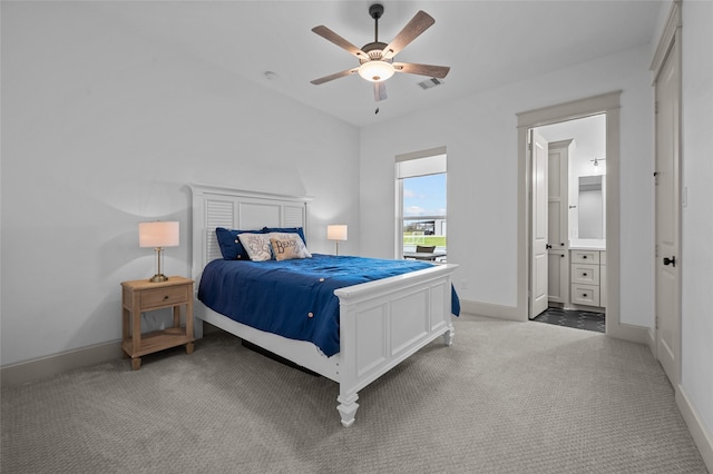 carpeted bedroom featuring ensuite bathroom and ceiling fan