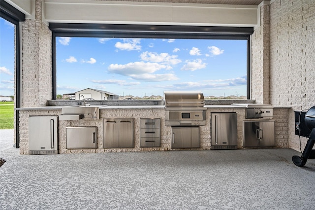 view of patio / terrace featuring exterior kitchen and area for grilling