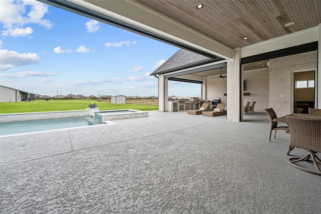 view of patio with a shed and exterior kitchen